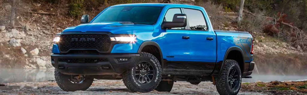 Blue Ram 1500 Rebel pickup truck parked on rugged terrain with a rocky landscape in the background.